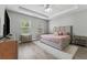 Relaxing main bedroom with tray ceiling, neutral paint, large bed, and natural lighting at 6111 Hadley Commons Dr, Riverview, FL 33578