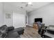 Well-lit office with a comfortable sofa, a desk and a large TV at 6111 Hadley Commons Dr, Riverview, FL 33578