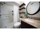 Bathroom featuring granite countertop vanity, shower with white curtain, and decorative shelves for functional storage at 7360 Ulmerton Rd # 29B, Largo, FL 33771