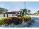 Street view of the Rose Tree Village community sign surrounded by shrubbery at 7360 Ulmerton Rd # 29B, Largo, FL 33771