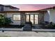 Inviting villa featuring a charming brick facade, tiled roof, and a cozy front patio area at 7360 Ulmerton Rd # 29B, Largo, FL 33771