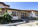 Inviting villa featuring a charming brick facade, tiled roof, and a cozy front patio area at 7360 Ulmerton Rd # 29B, Largo, FL 33771