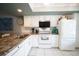 Updated kitchen with white cabinets, granite countertops, and modern appliances offers ample space for cooking and entertaining at 7360 Ulmerton Rd # 29B, Largo, FL 33771