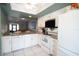 Modern kitchen featuring stainless steel appliances, white cabinets, and granite countertops for a sleek and functional design at 7360 Ulmerton Rd # 29B, Largo, FL 33771