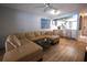 Inviting living room features a large sectional sofa and hardwood flooring, creating a warm and comfortable space at 7360 Ulmerton Rd # 29B, Largo, FL 33771