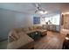 Inviting living room featuring wood floors, ceiling fan, and seamless transition to the kitchen with breakfast bar at 7360 Ulmerton Rd # 29B, Largo, FL 33771