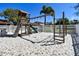 Community playground with swing set, slide and monkey bars over a sandpit at 7360 Ulmerton Rd # 29B, Largo, FL 33771