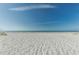 Beautiful beach with white sand and blue ocean water on a sunny day at 810 Lantana Ave, Clearwater Beach, FL 33767