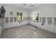 Bright bedroom with light grey floors, a ceiling fan, and bright, natural light at 810 Lantana Ave, Clearwater Beach, FL 33767