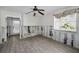 Bright bedroom with tile floors, a ceiling fan, and a window overlooking the trees at 810 Lantana Ave, Clearwater Beach, FL 33767
