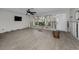 Spacious living room with new floors, exposed framing, and large windows at 810 Lantana Ave, Clearwater Beach, FL 33767