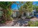 Charming patio area with brick pavers, mature trees, and an inviting seating area at 810 Lantana Ave, Clearwater Beach, FL 33767