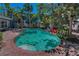 A backyard pool area with lounge chairs and lush landscaping, creating a serene retreat at 810 Lantana Ave, Clearwater Beach, FL 33767