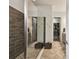 Modern bathroom featuring sleek glass shower and walk-in closet at 8725 Sorano Villa Dr, Tampa, FL 33647