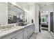 Stylish bathroom featuring a double vanity, granite countertops, and modern fixtures at 8725 Sorano Villa Dr, Tampa, FL 33647