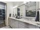 Modern bathroom featuring double sinks, granite countertops, and a walk-in closet at 8725 Sorano Villa Dr, Tampa, FL 33647