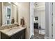 Bathroom vanity with granite counters, decorative mirror, and soft natural lighting providing a relaxing space at 8725 Sorano Villa Dr, Tampa, FL 33647