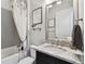 Bathroom vanity with granite counters, decorative mirror, a painting, and soft natural lighting to create a calming retreat at 8725 Sorano Villa Dr, Tampa, FL 33647