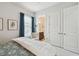 Cozy bedroom featuring a comfortable bed, stylish decor, and an adjacent bathroom for added convenience at 8725 Sorano Villa Dr, Tampa, FL 33647