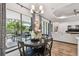 Bright dining area featuring sliding glass doors to patio and modern chandelier at 8725 Sorano Villa Dr, Tampa, FL 33647