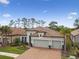 Beautiful home features a tile roof, three-car garage, landscaped yard and brick-paved driveway at 8725 Sorano Villa Dr, Tampa, FL 33647