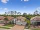 A gorgeous home featuring a tile roof, three-car garage, and a beautifully landscaped yard at 8725 Sorano Villa Dr, Tampa, FL 33647