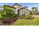 Well-manicured front yard featuring lush landscaping and healthy green grass at 8725 Sorano Villa Dr, Tampa, FL 33647