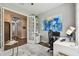 Stylish home office with modern desk, comfortable chair, and French doors for added privacy at 8725 Sorano Villa Dr, Tampa, FL 33647