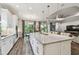 Expansive kitchen seamlessly connects to the living area, featuring stainless steel appliances and a large island at 8725 Sorano Villa Dr, Tampa, FL 33647