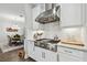 Modern kitchen showcasing stainless steel stove, granite countertops, white cabinetry, and adjacent dining area for seamless entertaining at 8725 Sorano Villa Dr, Tampa, FL 33647