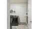 Functional laundry room equipped with modern appliances, ample storage, and tile flooring at 8725 Sorano Villa Dr, Tampa, FL 33647