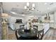 Open floorplan featuring kitchen island and stylish living room with tray ceiling at 8725 Sorano Villa Dr, Tampa, FL 33647