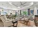 Living room with comfortable seating, kitchen bar and lots of light at 8725 Sorano Villa Dr, Tampa, FL 33647