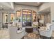 A relaxing community lounge area features large windows and neutral-toned furniture at 8725 Sorano Villa Dr, Tampa, FL 33647