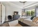 Relaxing bedroom with large window views, a chair, and dark wood accents at 8725 Sorano Villa Dr, Tampa, FL 33647