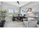 Bright office with a desk, chair, mountain-themed wall art, and a cozy armchair, with natural light streaming in at 8725 Sorano Villa Dr, Tampa, FL 33647