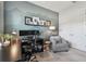 Office space features a large desk, chair, and gray chair with a lamp to enhance the comfortable workspace at 8725 Sorano Villa Dr, Tampa, FL 33647