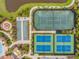 An aerial view of the community's recreational area, highlighting the bocce ball and tennis courts at 8725 Sorano Villa Dr, Tampa, FL 33647