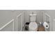 Toilet with sleek white design and decorative wall panels for added elegance at 8725 Sorano Villa Dr, Tampa, FL 33647