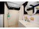 Bathroom featuring a tile shower and a decorative mirror over the sink at 9825 Casey Dr, New Port Richey, FL 34654
