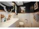Stylish bathroom featuring black walls, decorative mirror, tile, and a vanity at 9825 Casey Dr, New Port Richey, FL 34654