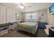 Cozy bedroom with natural light, ceiling fan, curtains, and blue furniture at 9825 Casey Dr, New Port Richey, FL 34654