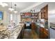 This kitchen features stone accents, wooden cabinets, a marble island and stainless steel appliances at 9825 Casey Dr, New Port Richey, FL 34654