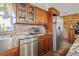The kitchen features a stone backsplash, wooden cabinets, and stainless steel appliances at 9825 Casey Dr, New Port Richey, FL 34654