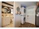 Laundry area featuring stacked washer and dryer plus adjacent bathroom at 9825 Casey Dr, New Port Richey, FL 34654