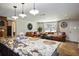 The open concept kitchen flows to the living room with leather furniture at 9825 Casey Dr, New Port Richey, FL 34654