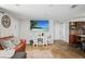 Cozy living room features natural stone floors, a decorative TV, and comfortable leather seating at 9825 Casey Dr, New Port Richey, FL 34654