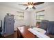 Home office with wood floors, two windows, ceiling fan, and room for a safe at 9825 Casey Dr, New Port Richey, FL 34654
