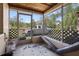 Enclosed porch with screen windows, a painted floor, and view of yard at 9825 Casey Dr, New Port Richey, FL 34654