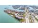 Aerial view of waterfront condo community, showcasing tennis courts, pool, and bay access at 103 1St E St # 115, Tierra Verde, FL 33715